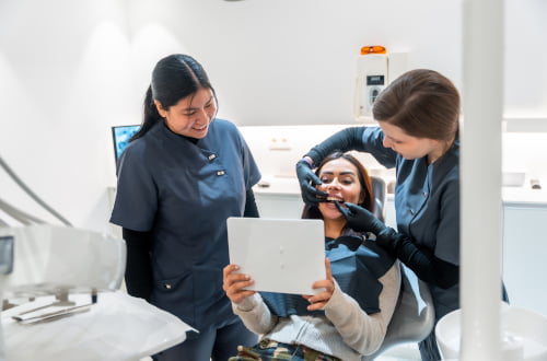 Dentist in a Markham dental clinic assisting a patient covered by the Canadian Dental Care Plan.