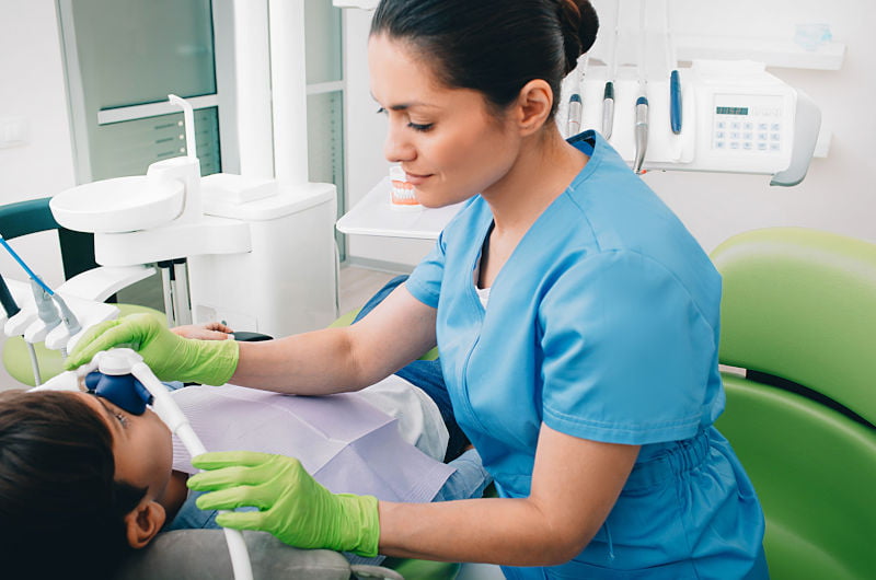 Dentist providing sedation during dental treatment for patient comfort