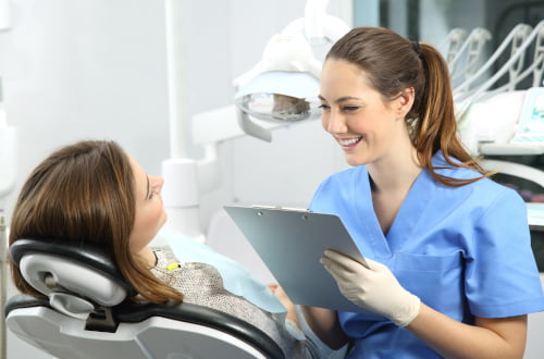 Patient smiling during a preventive dental check-up at a clinic accepting the Canadian Dental Care Plan.