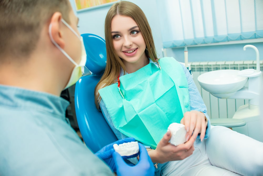 Smiling female patient in dental chair before IV sedation
