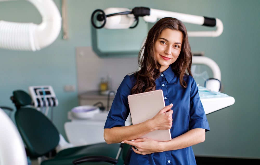 Canadian dentist discussing cosmetic treatment options and insurance with a patient